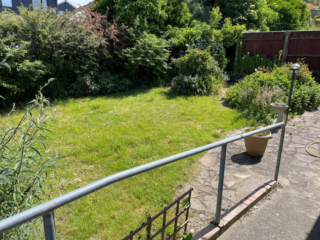 Lot: 129 - DETACHED CHALET BUNGALOW IN NEED OF UPDATING - rear garden with patio and lawned area